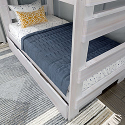 Modern wooden bunk bed with navy bedding and decorative pillows, ideal for stylish kids' bedroom design.