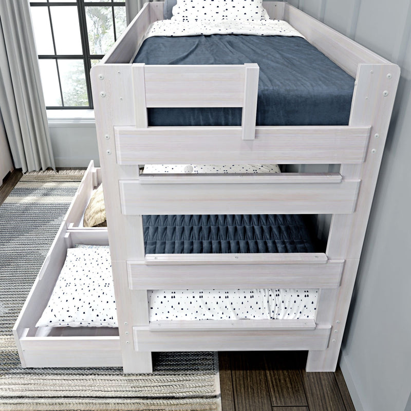 Three-level bunk bed with pull-out trundle drawers in a modern bedroom setting.