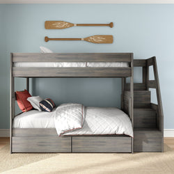 Gray wooden bunk bed with staircase and under-bed storage drawers, white quilted bedding and nautical oar wall decor in light-blue children's bedroom