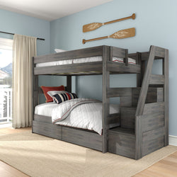 Gray wooden bunk bed with ladder and built-in storage drawers in a coastal kids' bedroom, white quilt, nautical striped pillows and wooden oar wall decor