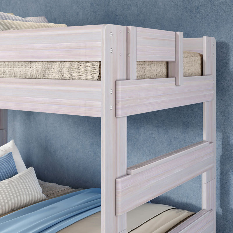 Whitewashed light-wood twin-over-twin bunk bed with guardrails, blue bedding and striped pillows in a modern children's bedroom
