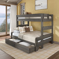 Gray wooden full-over-full bunk bed with under-bed storage drawers, plaid pillows and neutral bedding in a rustic lakeside bedroom