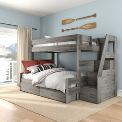 Gray rustic twin-over-full wooden bunk bed with built-in storage stairs and under-bed drawers in a coastal-style bedroom with light blue walls, nautical oar wall decor and large lake-view window