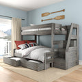 Gray rustic twin-over-full wooden bunk bed with built-in stairs and under-bed drawers in coastal bedroom with oar wall decor