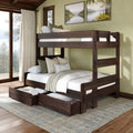 Solid wood twin-over-full bunk bed with pull-out trundle drawers, neutral bedding and pillows in a rustic lake-view bedroom