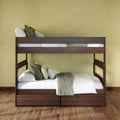 Modern dark walnut wooden bunk bed with built-in storage drawers, white linens and green accent pillows on hardwood floors in a minimalist bedroom