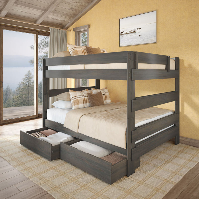 Gray wooden bunk bed with under-bed storage drawers, beige plaid bedding in a cozy rustic bedroom overlooking a lake