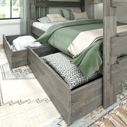Wooden bunk bed with green bedding and open under-bed storage drawers in a cozy bedroom.