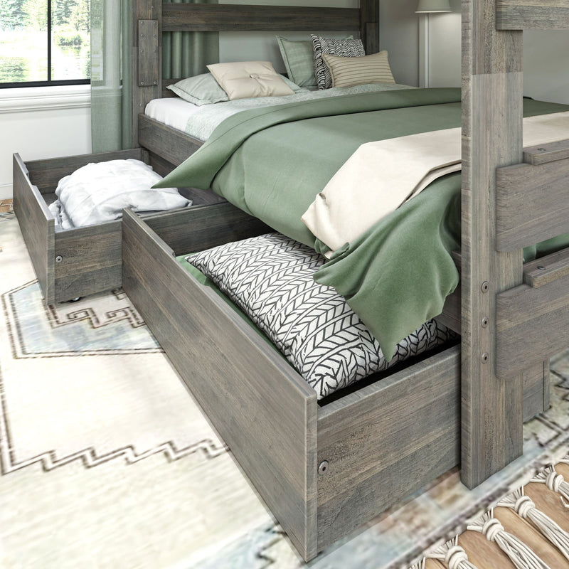 Wooden bunk bed with green bedding and open under-bed storage drawers in a cozy bedroom.