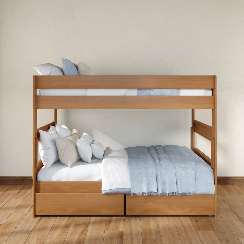 Modern solid wood bunk bed with light blue bedding and under-bed storage drawers in a minimalist kids' bedroom