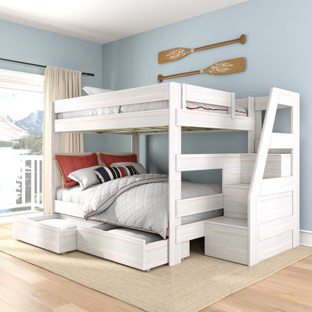 White wooden twin-over-full bunk bed with built-in staircase and pull-out storage drawers in a coastal blue bedroom with nautical oar wall decor and lake view