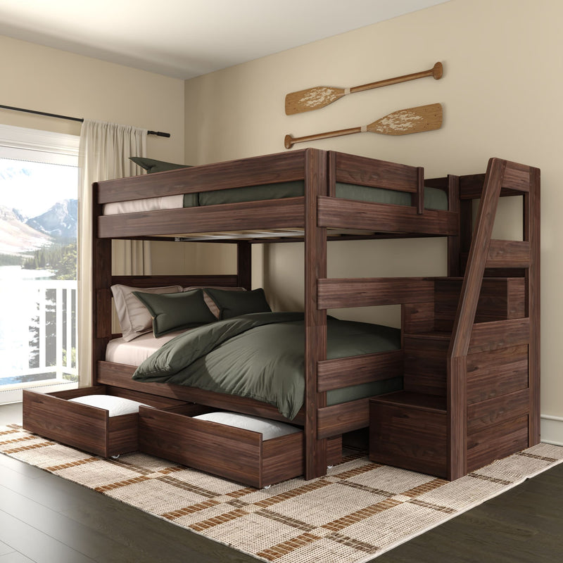 Dark walnut wooden twin-over-full bunk bed with built-in staircase, under-bed storage drawers and green bedding in a modern rustic bedroom with paddle wall decor and lake-view window