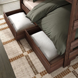 Solid wood bunk bed with green bedding and two under-bed storage drawers for space-saving bedroom organization