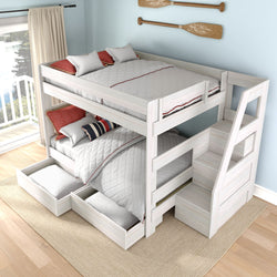 White wooden bunk bed with staircase and built-in storage drawers, gray quilted bedding and pillows, nautical oar wall decor and sunlit lake-view balcony in a coastal-style bedroom