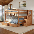 Wooden bunk bed with staircase and under-bed storage drawers, blue bedding in a cozy rustic bedroom with large windows and framed landscape painting