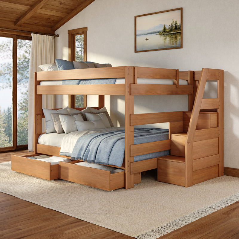 Wooden bunk bed with staircase and under-bed storage drawers, blue bedding in a cozy rustic bedroom with large windows and framed landscape painting