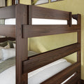Solid dark walnut twin-over-twin wooden bunk bed with white bedding and textured pillows in a modern rustic bedroom interior
