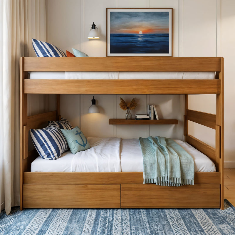 Modern wooden twin-over-full bunk bed with storage drawers, nautical striped pillows and blue throw in a coastal bedroom with ocean sunset wall art
