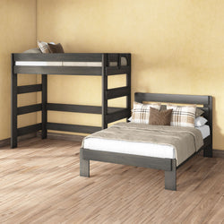 Grey wooden loft bunk bed and matching full-size bed in a modern farmhouse bedroom with neutral beige bedding, plaid throw pillows, hardwood floors and pale yellow walls