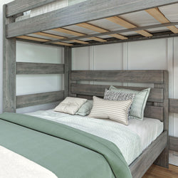 Rustic gray wooden bunk bed with comfortable bedding and pillows in a cozy bedroom setting.