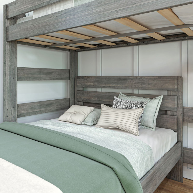 Rustic gray wooden bunk bed with comfortable bedding and pillows in a cozy bedroom setting.