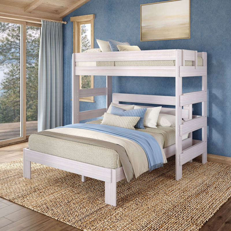 Whitewashed wooden bunk bed with blue and beige linen bedding in a coastal-style bedroom featuring a textured blue wall, large window and sheer curtains