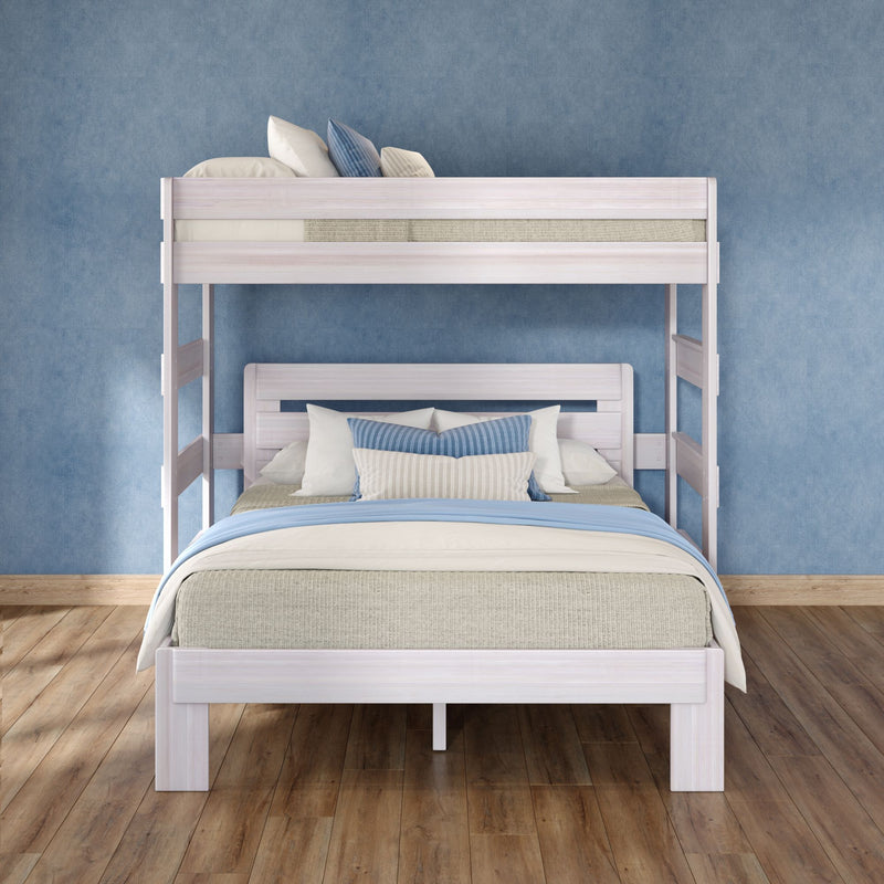White wooden bunk bed with blue and beige bedding and pillows against a textured blue wall on hardwood floor