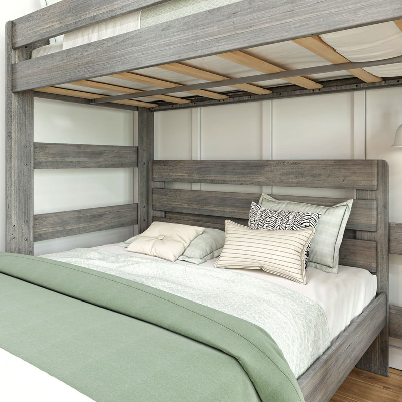 Rustic wooden bunk bed with green bedding and decorative pillows in a modern bedroom setting.