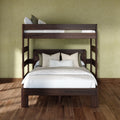 Solid dark wood bunk bed with white bedding and neutral pillows against a sage-green textured wall on hardwood floors, modern space-saving bedroom