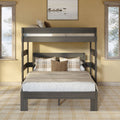 Rustic wooden bunk bed in a cozy neutral bedroom with plaid throw pillows, beige linen bedding, framed lake artwork and twin windows showing pine trees