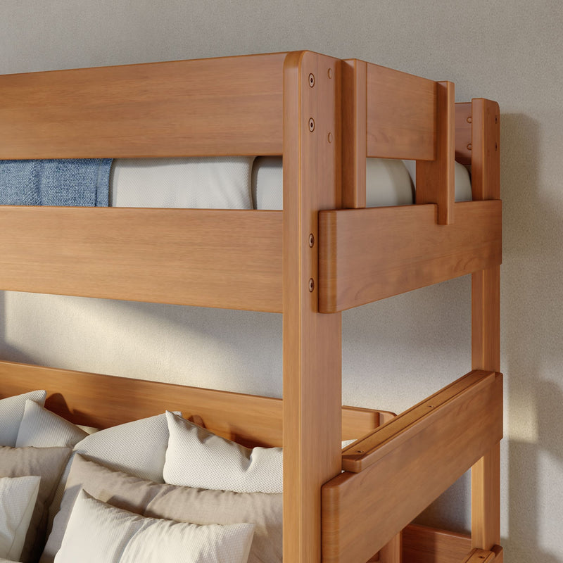 Solid wood bunk bed with natural finish, close-up of top guardrail, mattress and textured white pillows in modern kids' bedroom