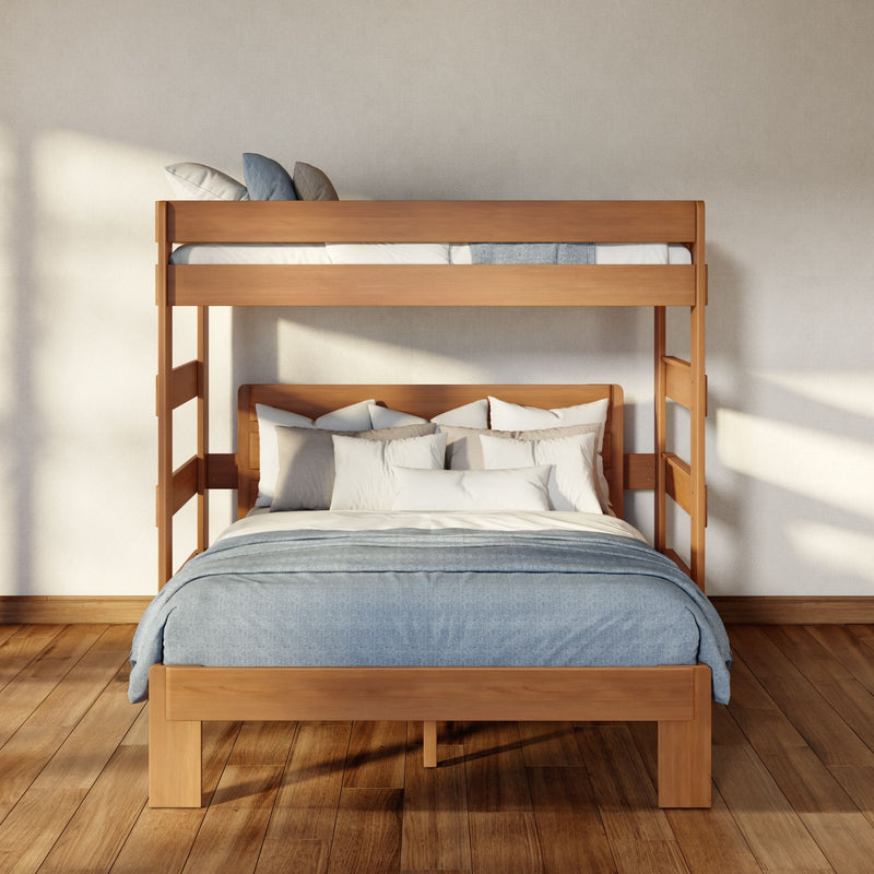 Minimalist natural wood bunk bed with blue-gray bedding and neutral pillows in a sunlit bedroom with hardwood floors and textured beige wall