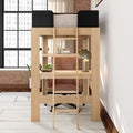 Wooden loft bed with built-in desk and ladder in modern loft apartment; compact home office with leather swivel chair, brass desk lamp, potted plants and exposed brick wall by large industrial window