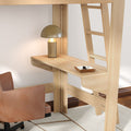 Light wood loft bed with built-in desk and ladder, cozy study nook featuring a gold table lamp, tan leather swivel chair and key tray