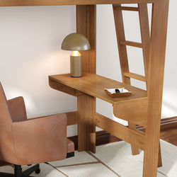 Wood loft bed with built-in desk and ladder, oak-finish space-saving workspace with brass mushroom lamp, brown leather swivel chair and catchall tray
