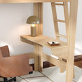 Light wood loft bed with built-in desk and ladder, modern brass table lamp, leather swivel chair and valet tray in a minimalist home office nook