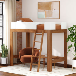Stylish wooden loft bed with ladder over cozy armchair in modern bedroom.