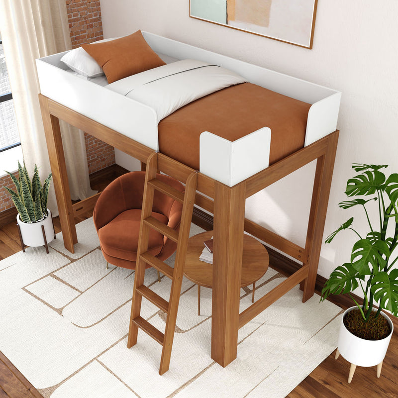 Modern wooden loft bed with white safety rails and ladder above a cozy rust-orange armchair and round table with indoor plants — space-saving bedroom design