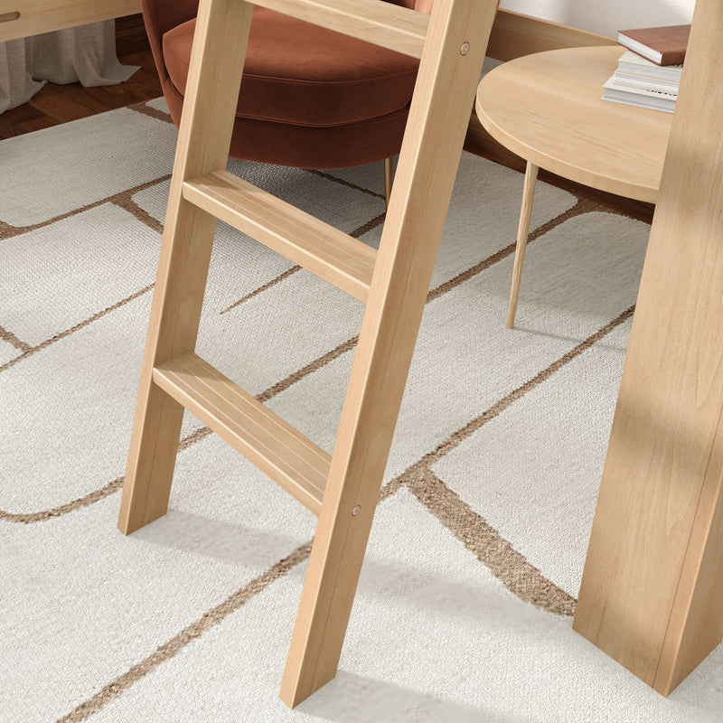 Light oak loft ladder in a modern bedroom nook with a rust velvet armchair, round wood side table, stacked books and a geometric cream area rug