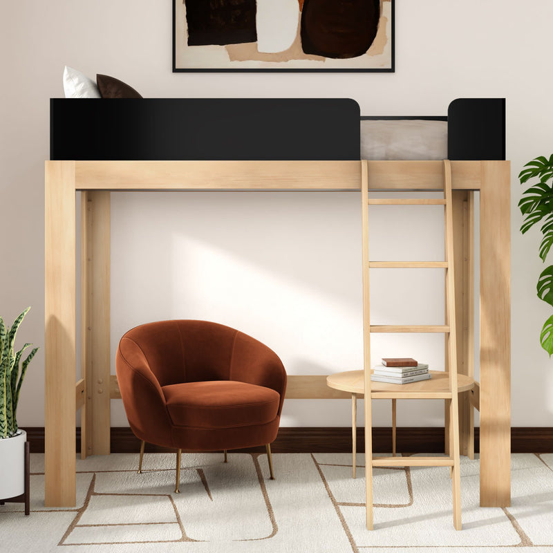 Light wood loft bed with ladder and black guardrail over a cozy reading nook featuring a rust velvet accent chair, round wooden side table with books, potted plant and abstract wall art — space-saving modern minimalist bedroom decor.
