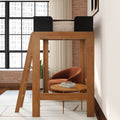 Modern wooden loft bed with ladder and cozy reading nook underneath featuring an orange velvet armchair, round wooden side table with books, exposed brick wall and large industrial grid windows