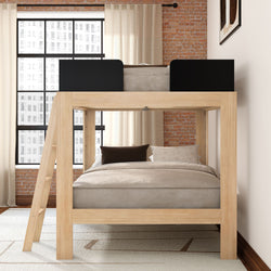 Modern wooden loft bunk bed with lower full bed, ladder and neutral bedding in an industrial bedroom with exposed brick wall and large grid window