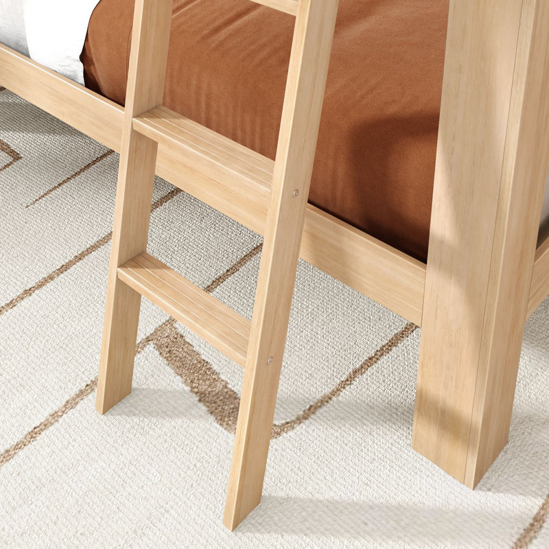 Close-up of light natural wood bunk bed ladder and frame with brown bedding on a textured beige geometric rug, modern bedroom furniture