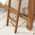 Wooden ladder for loft/bunk bed, close-up showing natural wood finish and textured beige geometric area rug