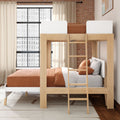 Modern Scandinavian wooden bunk bed with ladder and rust-orange bedding in industrial-style bedroom with exposed brick wall and large grid window