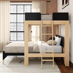 Modern loft-style wooden bunk bed with ladder in apartment bedroom, exposed brick wall, large industrial window and neutral beige bedding