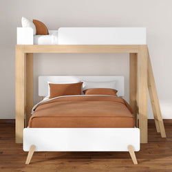 Modern wooden loft bunk bed with white panels and rust-orange bedding in a minimalist bedroom on hardwood floor