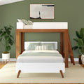 Modern wooden loft bed with white bedding in a stylish green bedroom featuring plants and minimalist wall art.