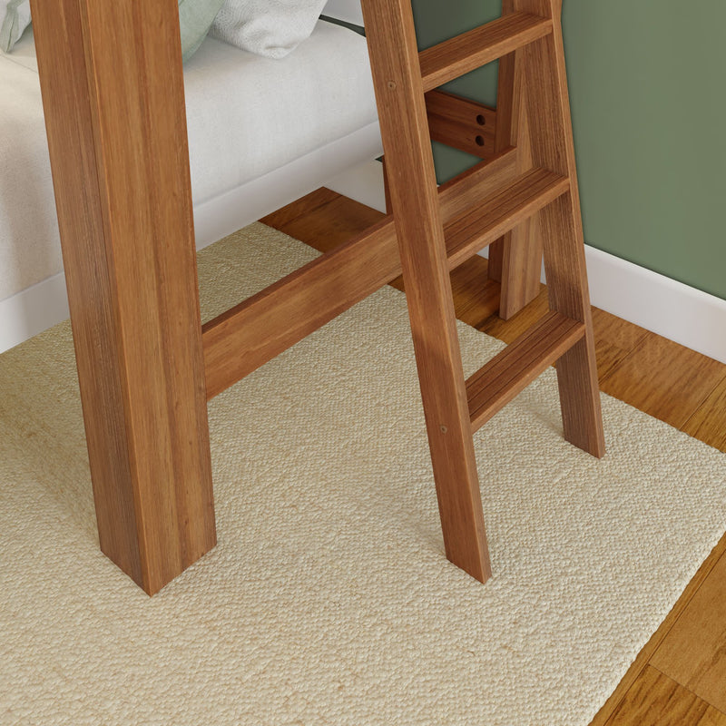 Wooden ladder on a beige carpet next to a green wall in a cozy bedroom setting.