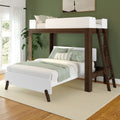 Modern wooden loft bed with green and white bedding in stylish bedroom.